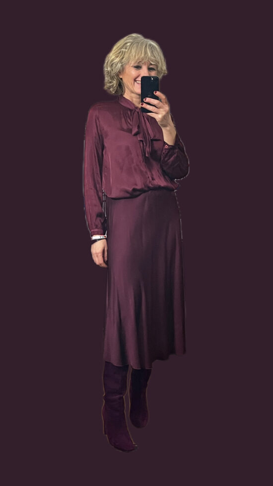 camicia in raso con fiocco bordeaux abbinata alla gonna longuette dello stesso colore